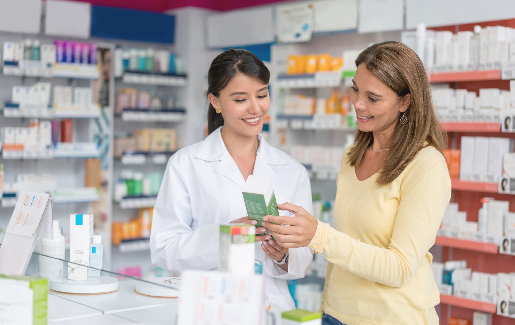 Pharmacy professionals assisting a customer with medical products